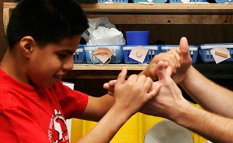boy using tactile sign language 